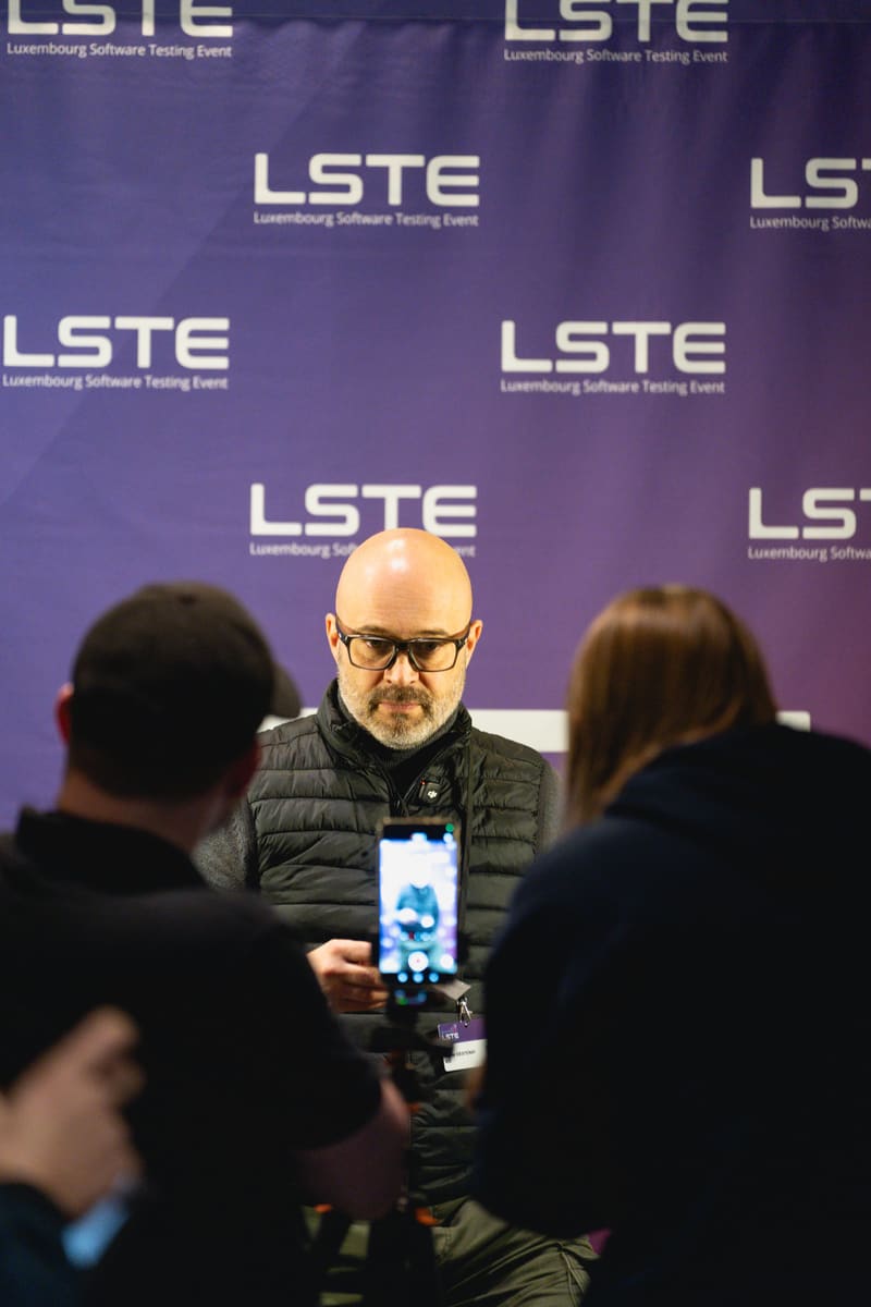 A media interview in front of the LSTE 2025 backdrop