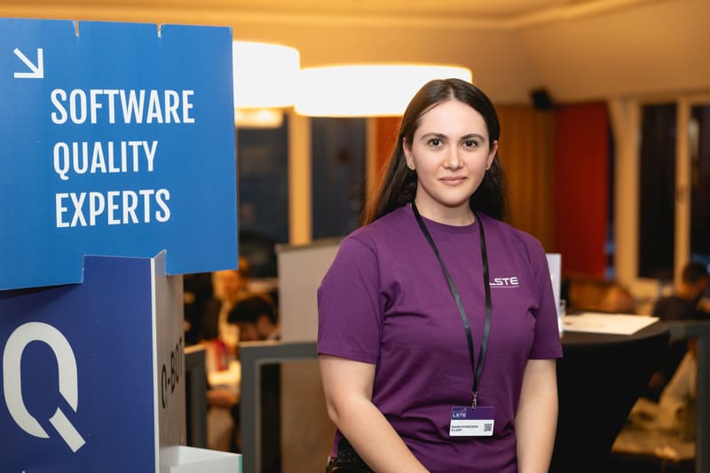 A Q-Leap team member at the Software Quality Experts booth, LSTE 2025