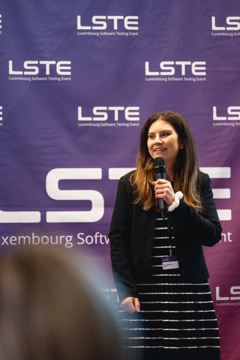 A speaker addressing the audience with a microphone at LSTE 2025