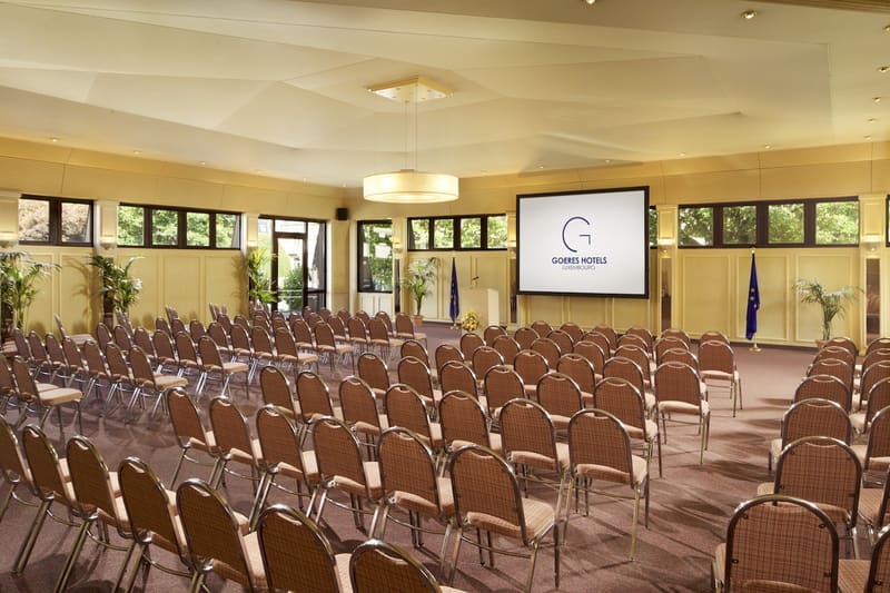 The Parc Belle-Vue conference room set up theatre-style, facing the stage screen